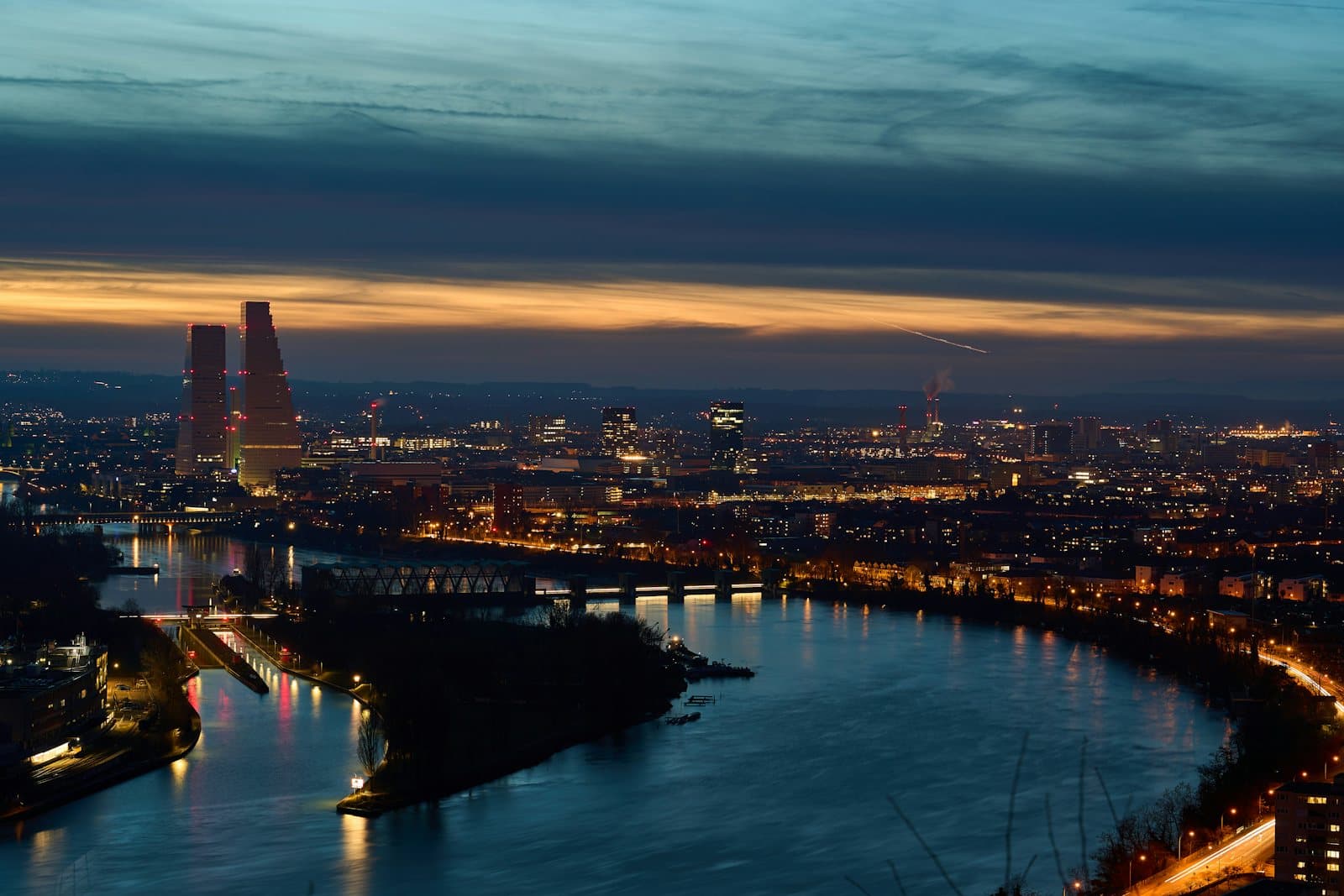 City skyline across a river at blue hour