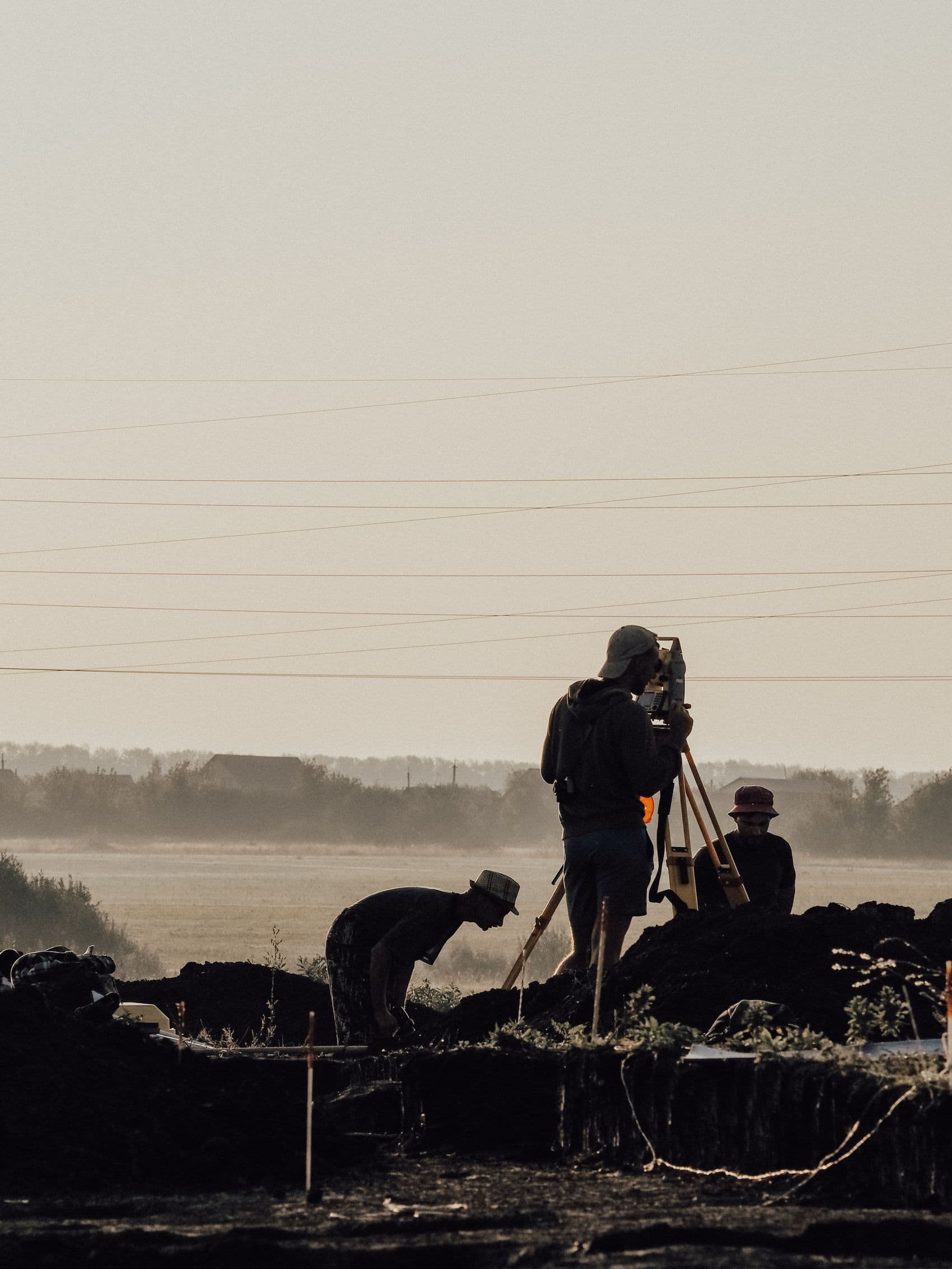 Surveyor sighting through a total station on site